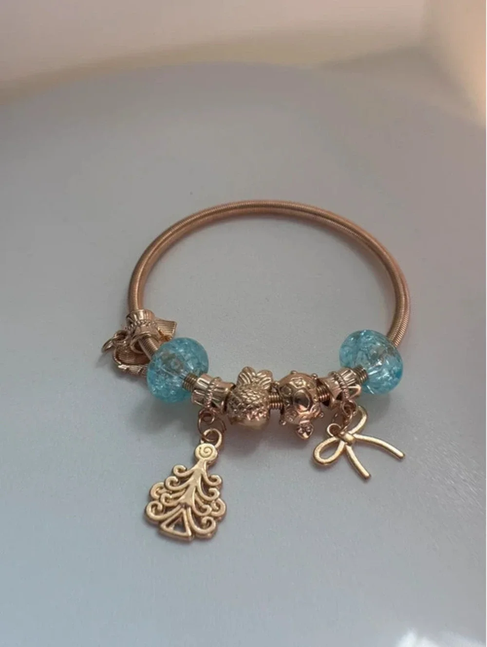 Light blue, gold tone charm bracelet